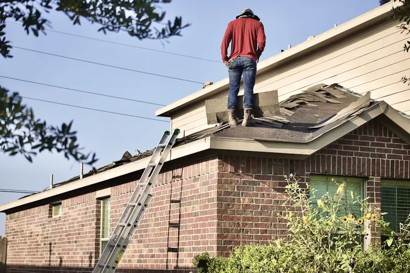 Professional roofer working on a residential roof in Gallaway